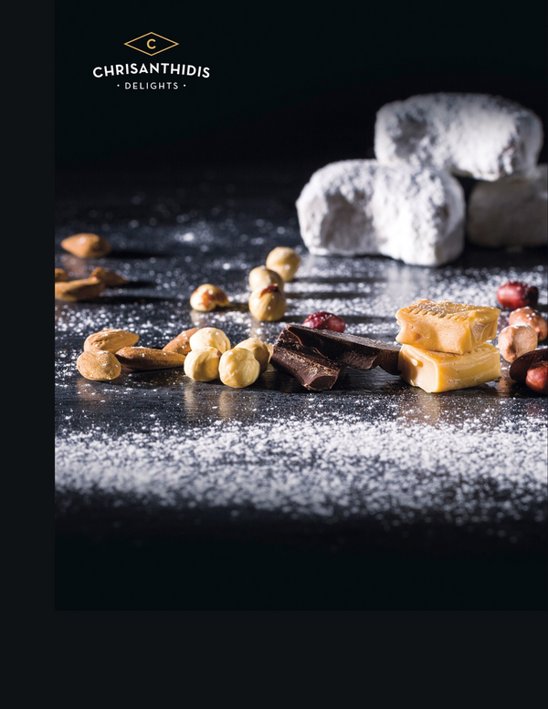 A collection of cookies, nuts and chocolates on a table sprinkled with powdered sugar