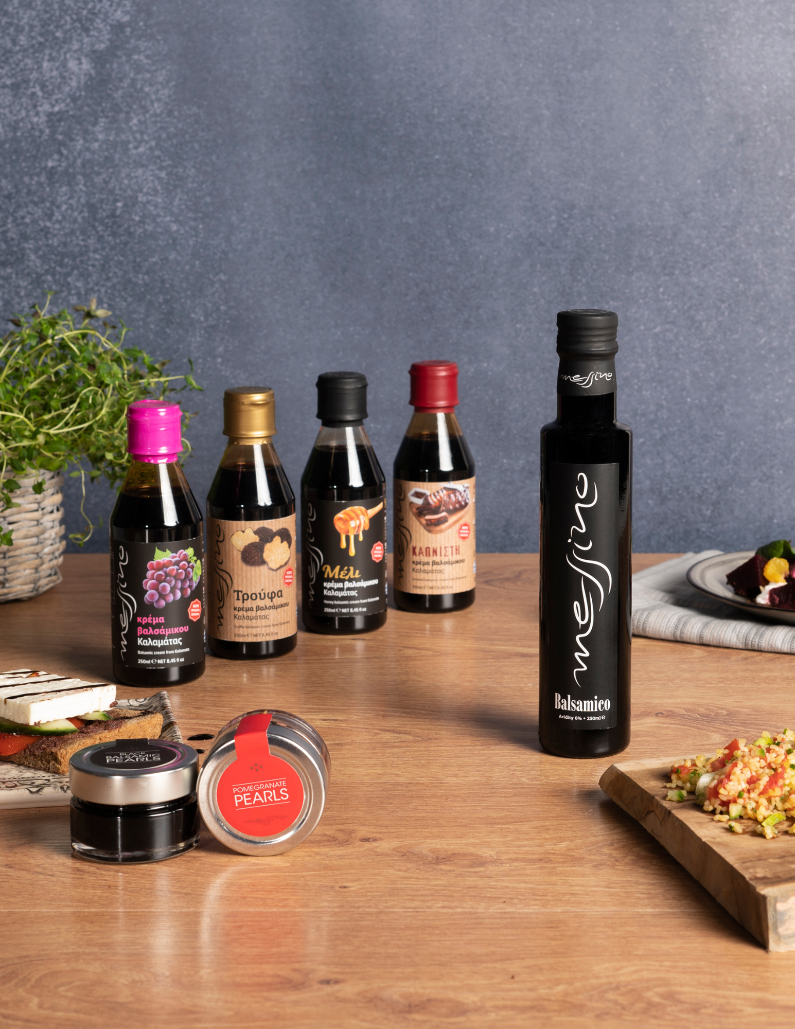A collection of Messino vinegar products including balsamic vinegar, four flavors of glazes and two flavors of balsamic pearls