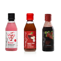 Three bottles of Messino Balsamic cream products on a white background