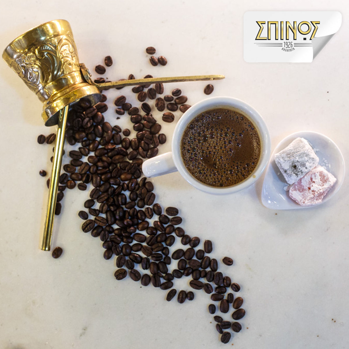 Spilled coffee beans next to cup of greek coffee and sweets