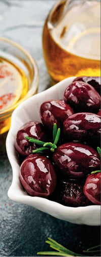 Hermes Dimarakis Estate olives in a plate with olive oil in the background