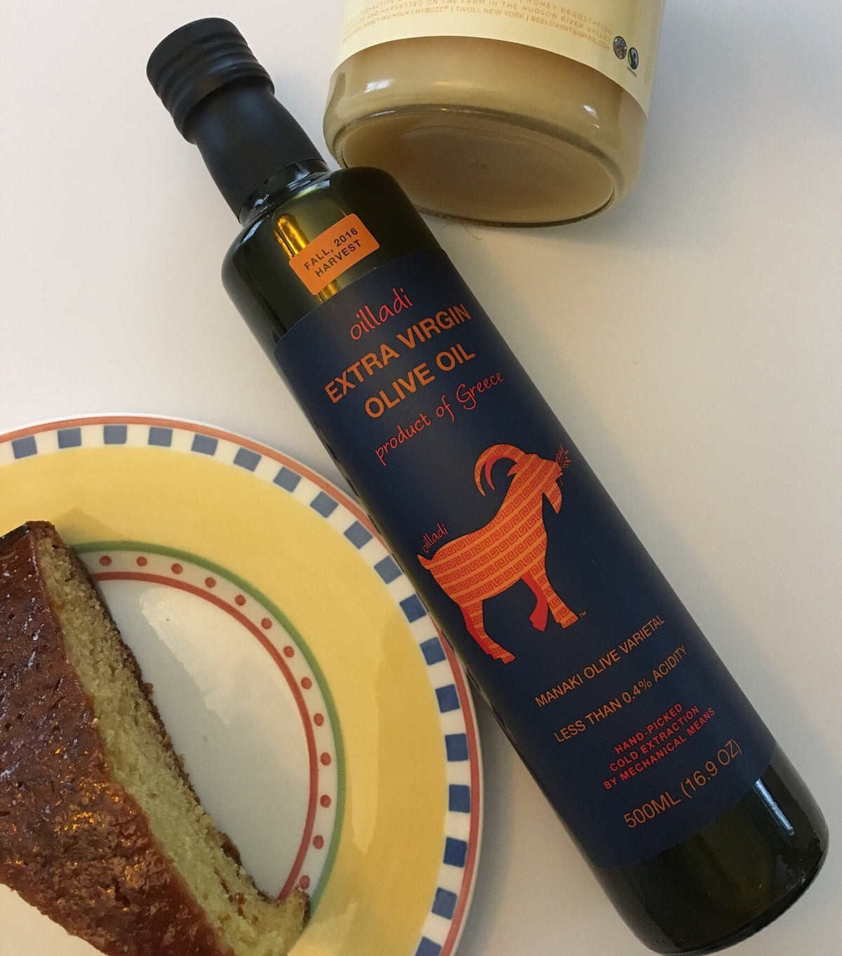 Extra virgin olive oil EVOO imported from Greece with piece of cake on a plate