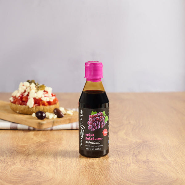 Bottle of Messino Classic Balsamic Glaze with bruschetta in the background