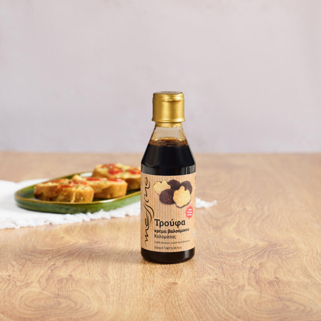 Bottle of Messino Balsamic Glaze with Truffle and plated bruschetta in the background