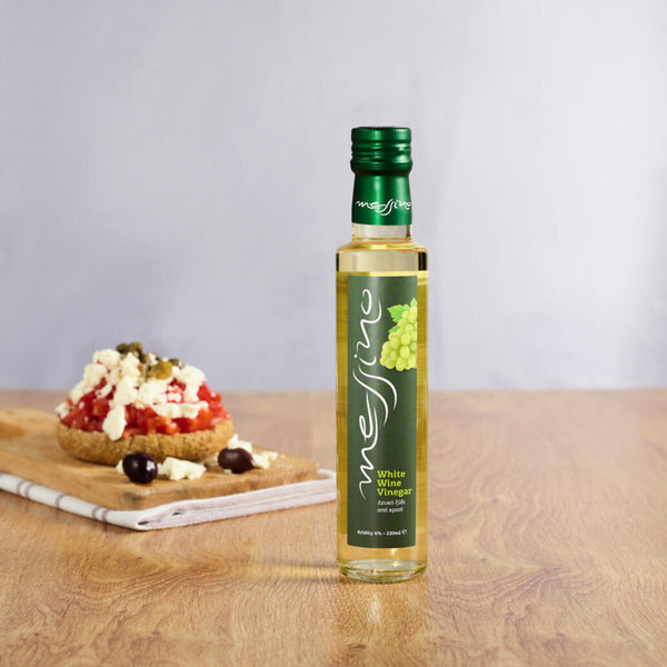 Bottle of Messino White Wine Vinegar and bruschetta in the background