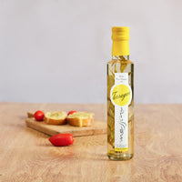 Bottle of Messino White Wine Vinegar with Tarragon and bruschetta in the background