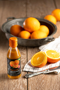 Bottle of Messino Blasamic Glaze with Orange and oranges in the background