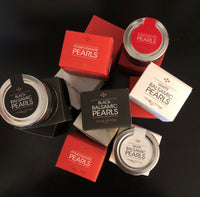 Assorted flavors of Messino Balsamic Pearls and packaging