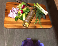 Bottle of Messino White Balsamic Vinegar on cutting board with vegetables