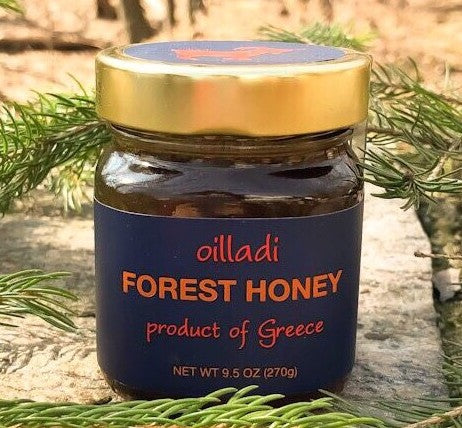 Jar of Oilladi forest honey surrounded by branches